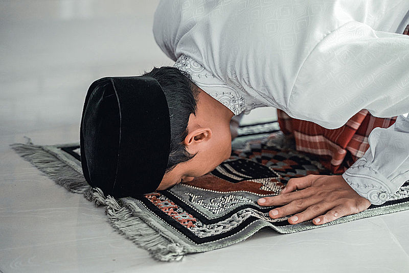 Muslim man praying during coronavirus quarantine